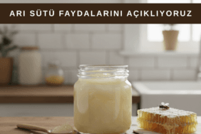 Cam kavanozda saf arı sütü ve yanında doğal arı ürünleri